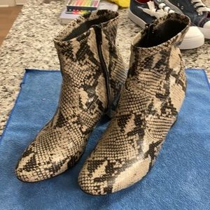 Women’s snake-print zip booties.